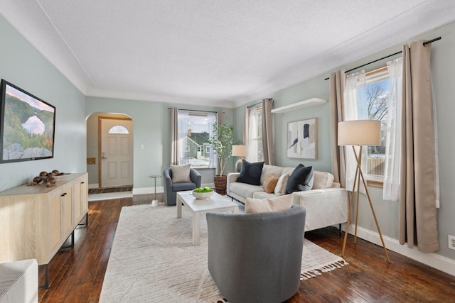 living room with dark wood-type flooring and a textured ceiling