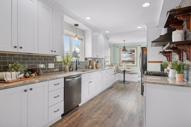 kitchen featuring sink, pendant lighting, white cabinetry, and appliances with stainless steel finishes