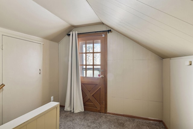 additional living space with light colored carpet and lofted ceiling