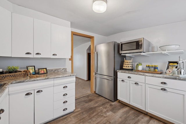 kitchen featuring dark wood-type flooring, white cabinetry, and stainless steel appliances