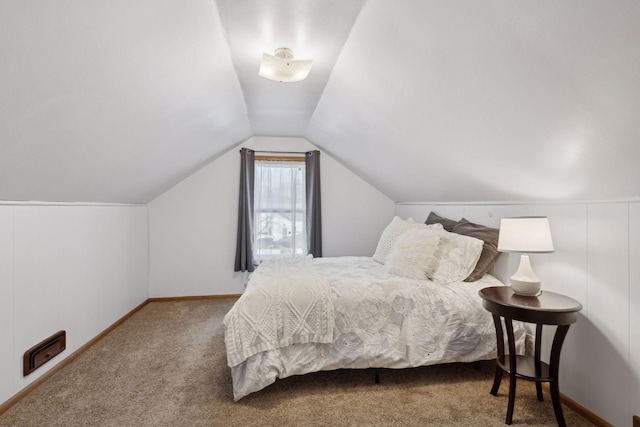 bedroom featuring vaulted ceiling and carpet floors