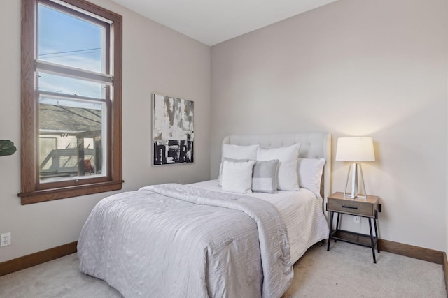 bedroom featuring light colored carpet