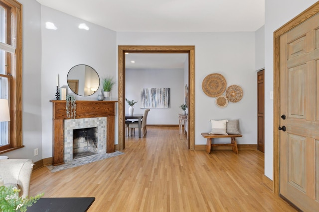 interior space featuring a fireplace and light hardwood / wood-style flooring