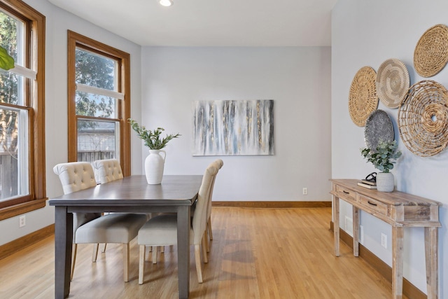 dining space with light hardwood / wood-style floors