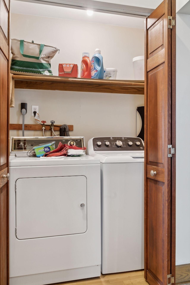 laundry room with light hardwood / wood-style floors and independent washer and dryer