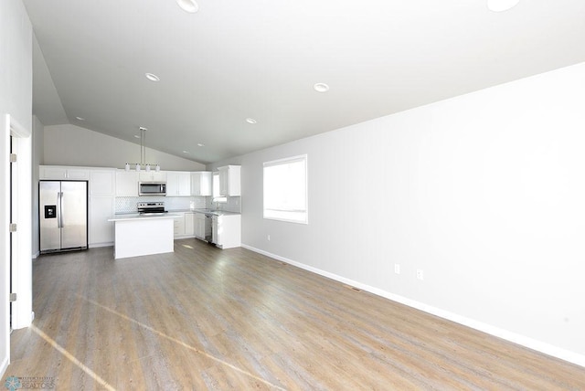 unfurnished living room featuring light hardwood / wood-style flooring and vaulted ceiling