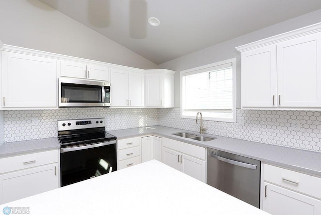 kitchen featuring tasteful backsplash, white cabinetry, sink, and appliances with stainless steel finishes