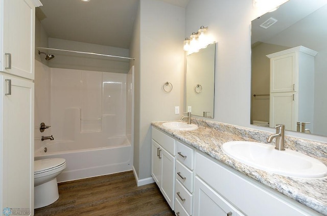 full bathroom with vanity,  shower combination, hardwood / wood-style flooring, and toilet