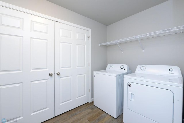 washroom featuring separate washer and dryer and light hardwood / wood-style floors