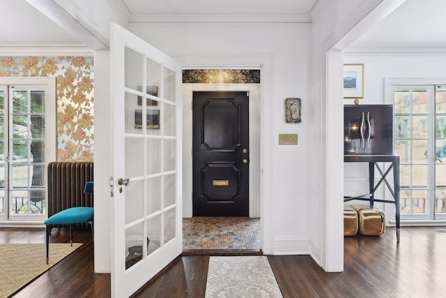 foyer featuring dark hardwood / wood-style flooring, crown molding, radiator heating unit, and french doors