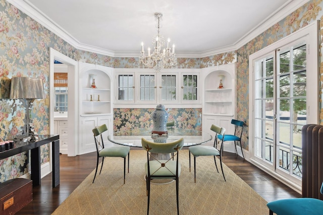 dining space featuring crown molding, dark hardwood / wood-style floors, built in features, and a chandelier