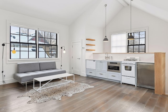 unfurnished living room with hardwood / wood-style flooring, a wealth of natural light, and beamed ceiling