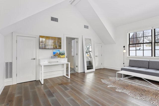 living area with high vaulted ceiling and dark hardwood / wood-style flooring