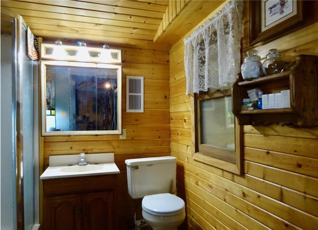 bathroom with vanity, toilet, wooden ceiling, and wood walls