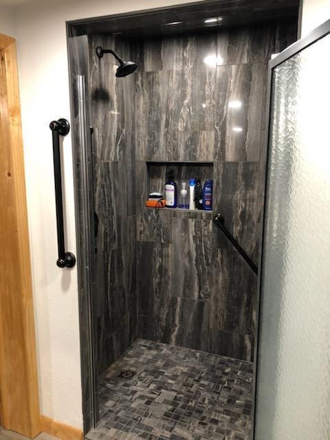 bathroom with tiled shower