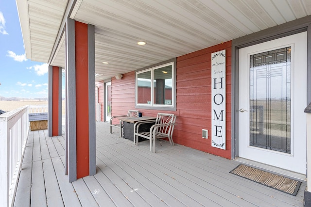 wooden terrace featuring covered porch
