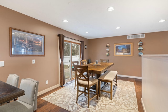 dining room featuring baseboards, visible vents, recessed lighting, and wood finished floors