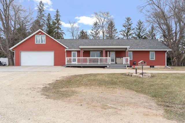 ranch-style house with driveway, covered porch, a shingled roof, and a front lawn