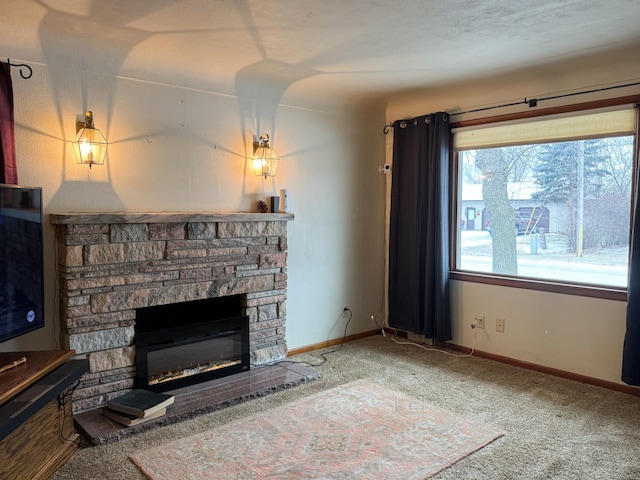 unfurnished living room featuring carpet flooring, a stone fireplace, and a textured ceiling