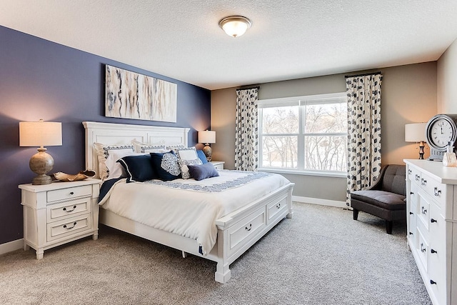 bedroom featuring light colored carpet and a textured ceiling