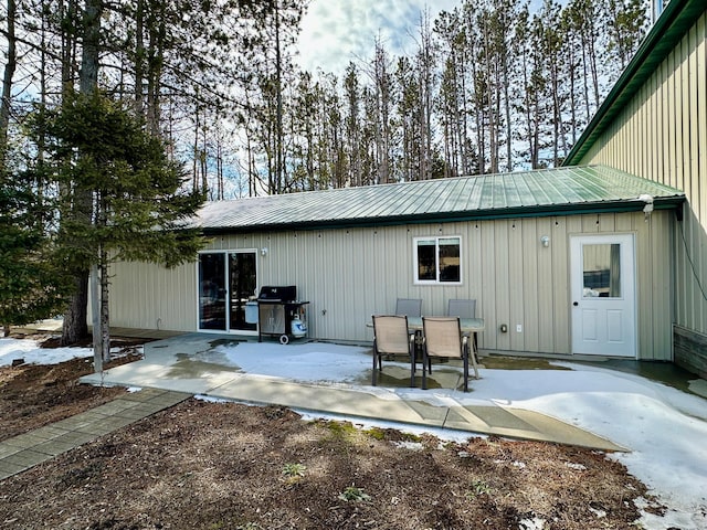 rear view of property featuring a patio area and metal roof