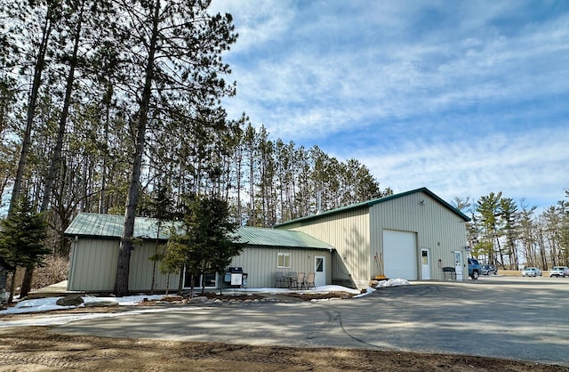 view of building exterior featuring a detached garage