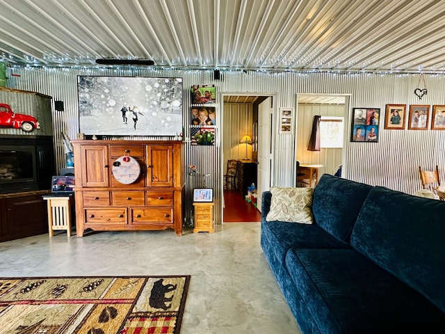 living area featuring concrete floors and metal wall