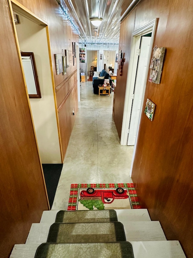 hall with concrete flooring