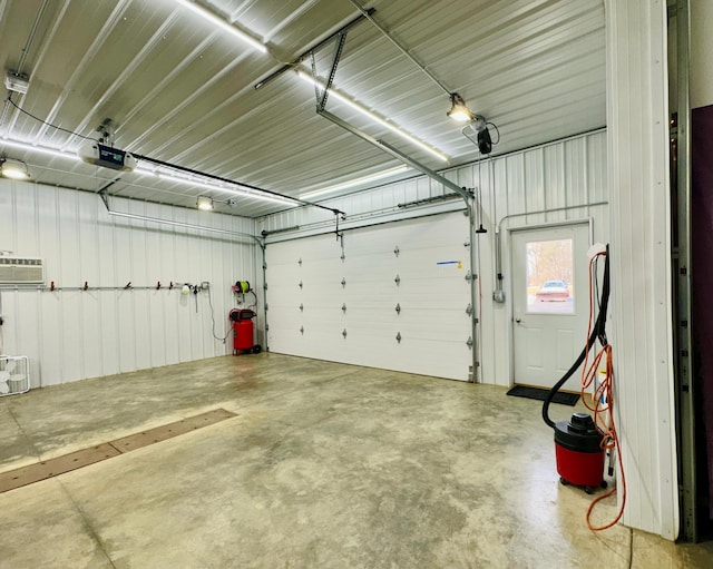 garage featuring metal wall and a garage door opener
