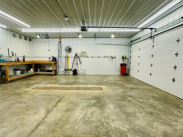 garage featuring metal wall and a garage door opener