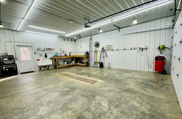 garage with a garage door opener, a sink, and metal wall