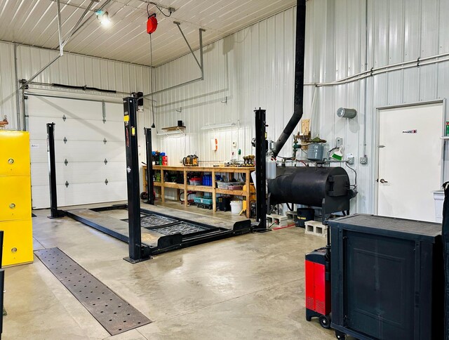 garage featuring metal wall and a workshop area