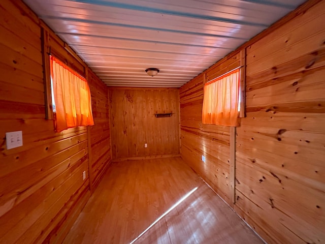 corridor featuring wood walls and light wood-style floors