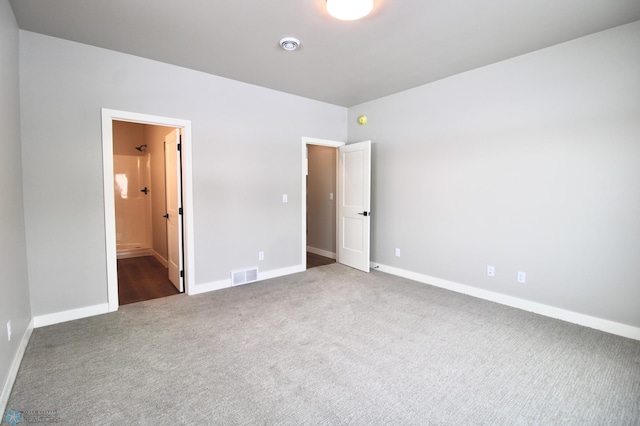 unfurnished bedroom featuring dark carpet