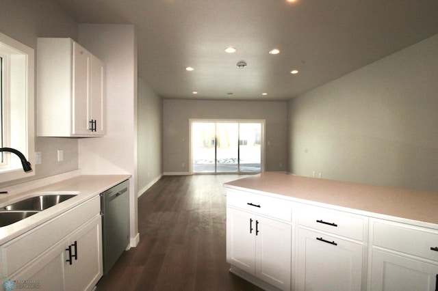 kitchen featuring white cabinetry, stainless steel dishwasher, dark hardwood / wood-style floors, and sink