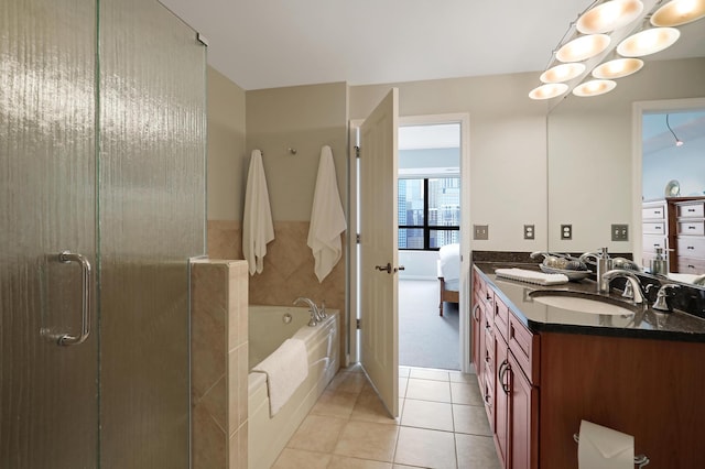 bathroom featuring tile patterned floors, vanity, and plus walk in shower