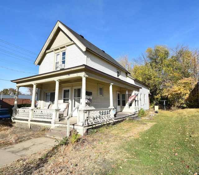 country-style home with covered porch and a front yard