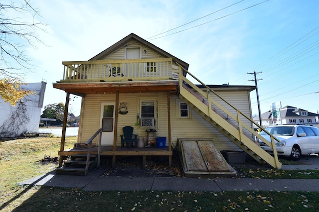 back of property featuring a balcony