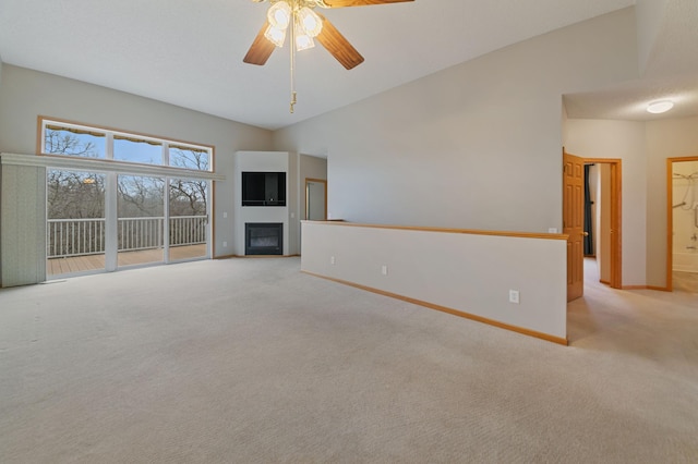 unfurnished living room featuring ceiling fan, light carpet, and high vaulted ceiling