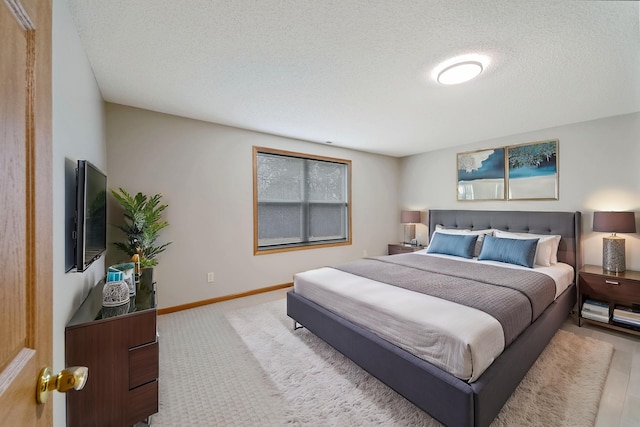 carpeted bedroom with a textured ceiling