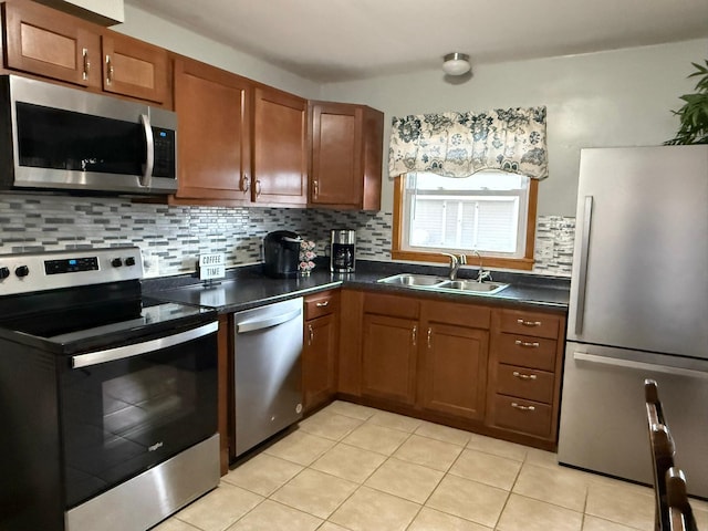 kitchen with sink, light tile patterned floors, stainless steel appliances, and tasteful backsplash