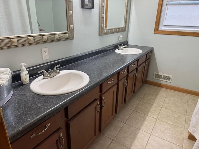 bathroom with tile patterned floors and vanity