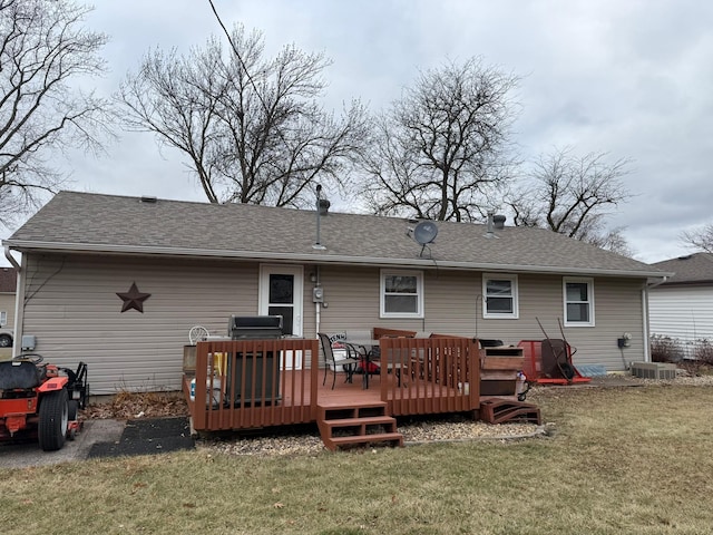 back of house featuring a wooden deck and a yard