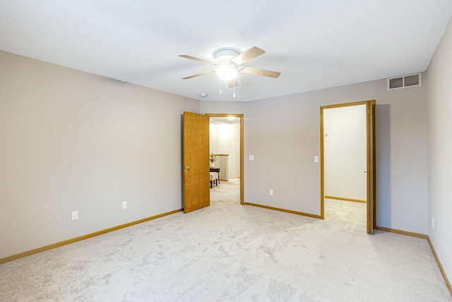 unfurnished room featuring light colored carpet and ceiling fan