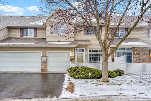 townhome / multi-family property featuring a garage