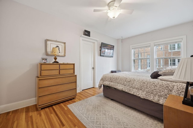 bedroom with ceiling fan and light hardwood / wood-style flooring