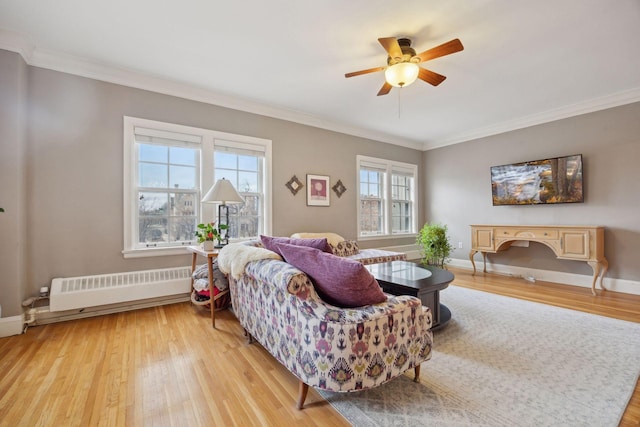 living room with ornamental molding, radiator, and light hardwood / wood-style flooring