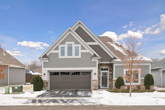 craftsman house featuring cooling unit and a garage