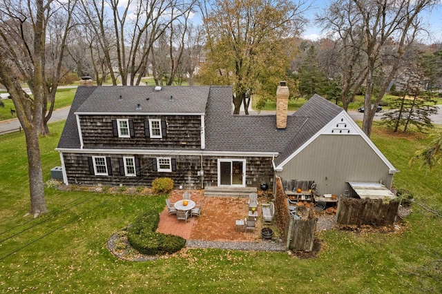 back of house featuring a patio and a lawn