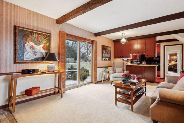 living room with beam ceiling and light colored carpet